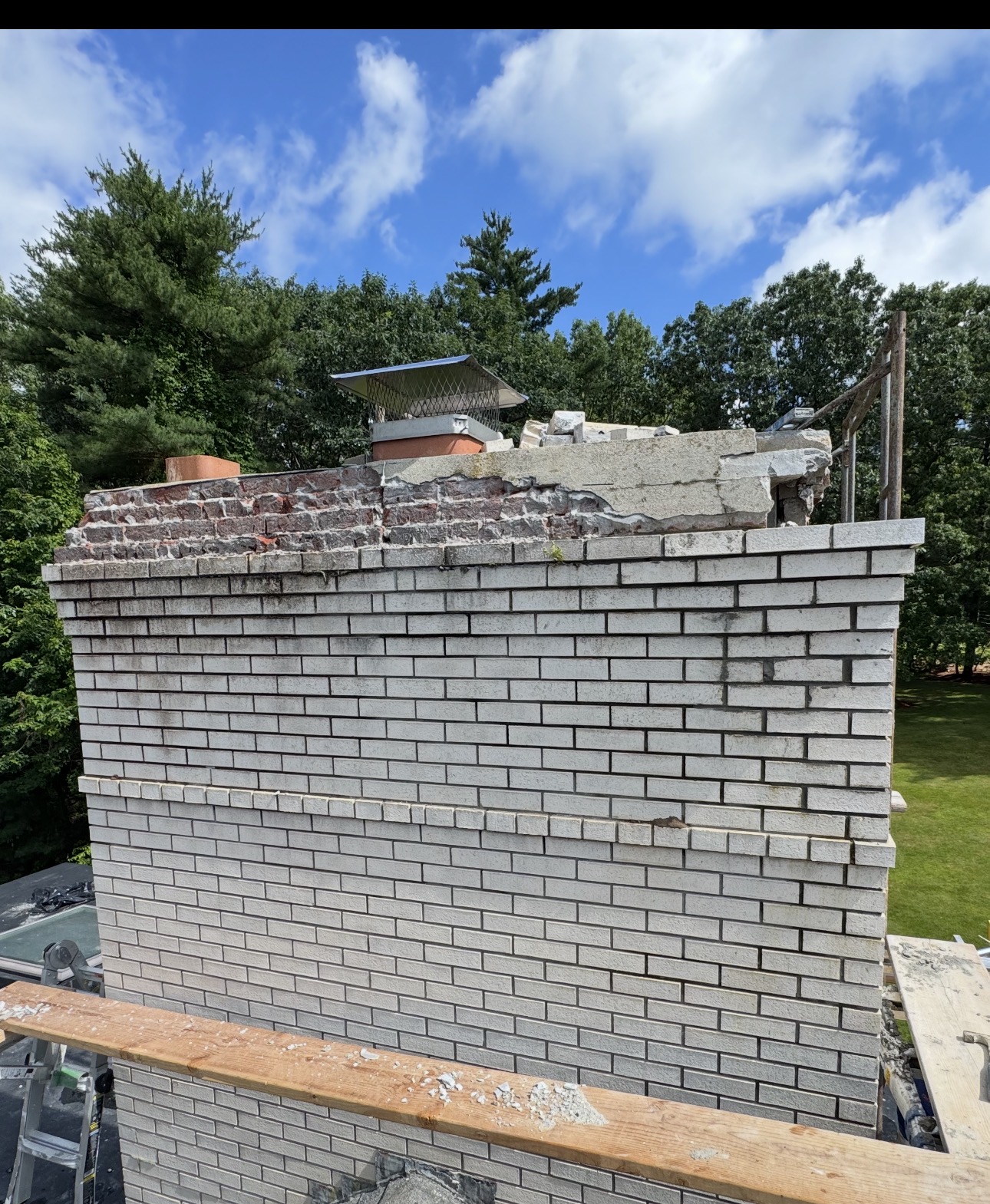 Brick chimney before cap restoration with the deteriorated crown removed