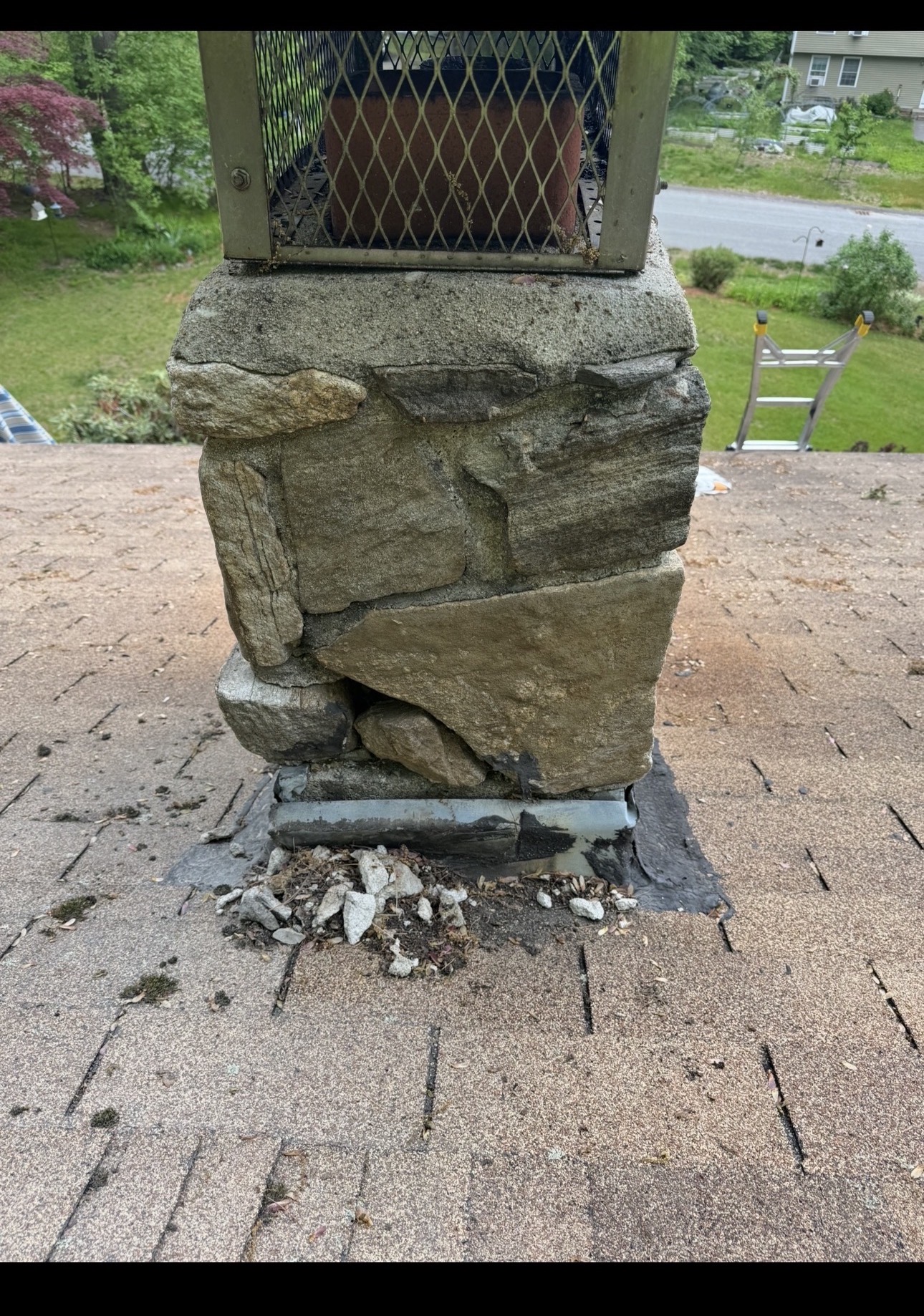Stone chimney before restoration with deteriorated and missing mortar joints
